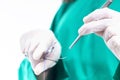 Doctor holding surgical forceps suture needle, suturing material Royalty Free Stock Photo