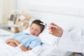 Doctor holding syringe with boy in hospital