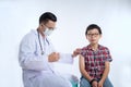 doctor holding a syringe with injection vaccination. Boy is afraid. Teen boy in fear of injection. office on white background Royalty Free Stock Photo