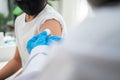 Doctor holding syringe for prepare vaccinated in the shoulder of Asian boy kids in the hospital. Pediatrician makes vaccination Royalty Free Stock Photo