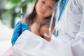 Doctor holding syringe for prepare vaccinated in the shoulder of Asian girl kids in the hospital. Pediatrician makes vaccination Royalty Free Stock Photo