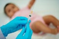 doctor holding syringe and preparing vaccine giving injection to baby Royalty Free Stock Photo