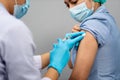 Doctor holding syringe and using cotton before make injection to nurse or Medical professionals in mask. Covid-19 or coronavirus Royalty Free Stock Photo