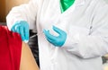 Doctor holding syringe and using cotton before make injection to patient in medical mask. Covid-19 or coronavirus vaccine concept Royalty Free Stock Photo