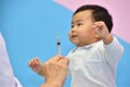 Doctor holding syringe with vaccine for Asian baby Royalty Free Stock Photo