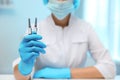 Doctor holding syringes with COVID-19 vaccine on blurred background, closeup