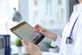 Doctor is holding tablet with heart cardiogram