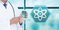 Doctor holding tablet with medical science interface hexagon icon