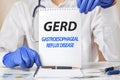 Doctor holding a tablet with text: gerd - gastroesophageal reflux disease, medical concept Royalty Free Stock Photo