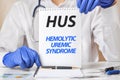 Doctor holding a tablet with text: HUS. HUS - Hemolytic Uremic Syndrome, medical concept Royalty Free Stock Photo