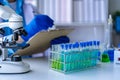 Doctor holding test tube with blue liquid, laboratory analysis for microscopic Royalty Free Stock Photo