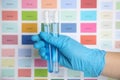 Doctor holding test tubes with liquid near sample chart, closeup Royalty Free Stock Photo