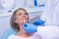 Doctor holding tooth whitening equipment by patient