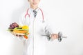Doctor holding tray with heart healthy foods and dumbbell Royalty Free Stock Photo