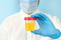 Doctor holding urine sample container for medical urinalysis Royalty Free Stock Photo