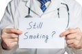 Doctor holds a clipboard with still smoking label Royalty Free Stock Photo