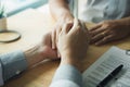 Doctor holds hands and leaves comforting counselors to patient