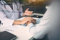 Doctor holds hands and leaves comforting counselors to patient Royalty Free Stock Photo