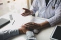 Doctor holds hands and leaves comforting counselors to patient