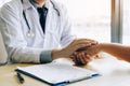 Doctor holds hands and leaves comforting counselors to patient Royalty Free Stock Photo