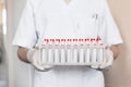 Doctor holds in hands a stand with test tubes for coronavirus analysis. Virus Covid-19 Royalty Free Stock Photo