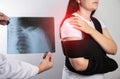 The doctor holds in his hand a medical x-ray of a dislocated humerus and a fractured collarbone against the background Royalty Free Stock Photo