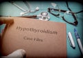 Doctor holds in its hands a book on the Hypothyroidism