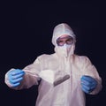 The doctor holds a medical mask - respirator n95 ffp2, black background