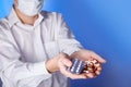 Doctor holds multi-colored pills and pack of different tablet blisters in hands. Panacea, life save service, prescribe medicament, Royalty Free Stock Photo