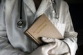 Doctor holds in a Munchausen syndrome book in a hospital.