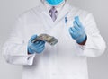 Doctor holds a pack of paper money, anti-corruption concept, bribe and payment Royalty Free Stock Photo