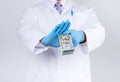 Doctor holds a pack of paper money and refuses to take a bribe Royalty Free Stock Photo