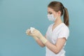 Doctor in mask and gloves holds a band-aid on a blue background Royalty Free Stock Photo