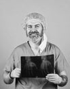 Doctor holds pictures of bones. Fracture and bone damage. Doctor examines radiographic snapshot of wrist. Surgeon