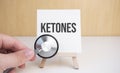 Doctor holds stethoscope and easel with text ketones