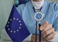 Doctor holds stethoscope with European Union flag Royalty Free Stock Photo