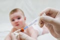 Doctor holds syringe to vaccinate baby with injection Royalty Free Stock Photo