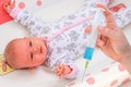 Doctor holds syringe to vaccinate newborn baby Royalty Free Stock Photo