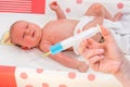 Doctor holds syringe to vaccinate newborn baby Royalty Free Stock Photo