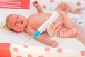 Doctor holds syringe to vaccinate newborn baby Royalty Free Stock Photo