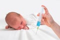 Doctor holds syringe to vaccinate newborn baby with injection Royalty Free Stock Photo