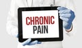 Doctor in holds a tablet with text chronic pain