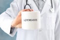 Doctor holds toilet paper with Hemorrhoids on background, close up