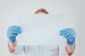 Doctor holds a white sheet of paper. Copy space. Royalty Free Stock Photo