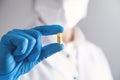 Doctor holds yellow pill in his hand. Medical concept Royalty Free Stock Photo