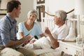 Doctor On Home Visit Discussing Health Of Senior Male Patient With Wife Royalty Free Stock Photo