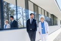 Doctor and hospital administrator walking into hospital, talking. Royalty Free Stock Photo