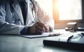 Doctor in hospital on duty in white coat reading patient's information with pen in hand, filling prescription or checklist