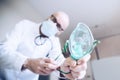 Doctor in hospital putting on oxygen mask. Breathing problems Royalty Free Stock Photo