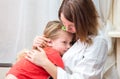 Doctor hugs and cuddle the little sick girl
